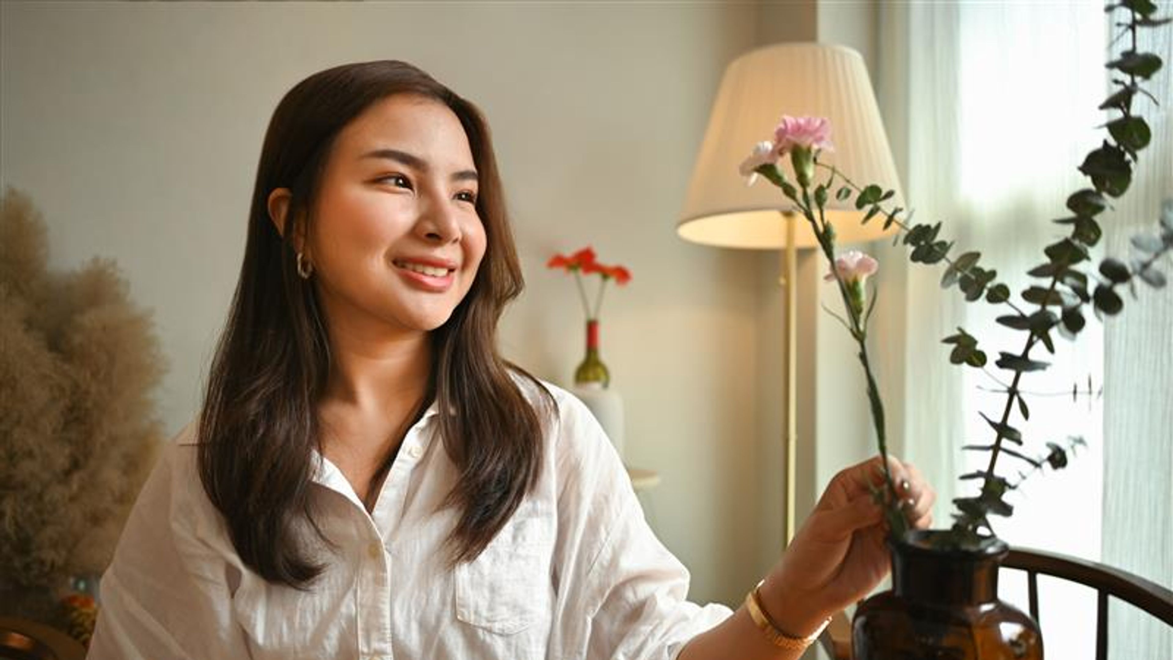A woman making a flower vase