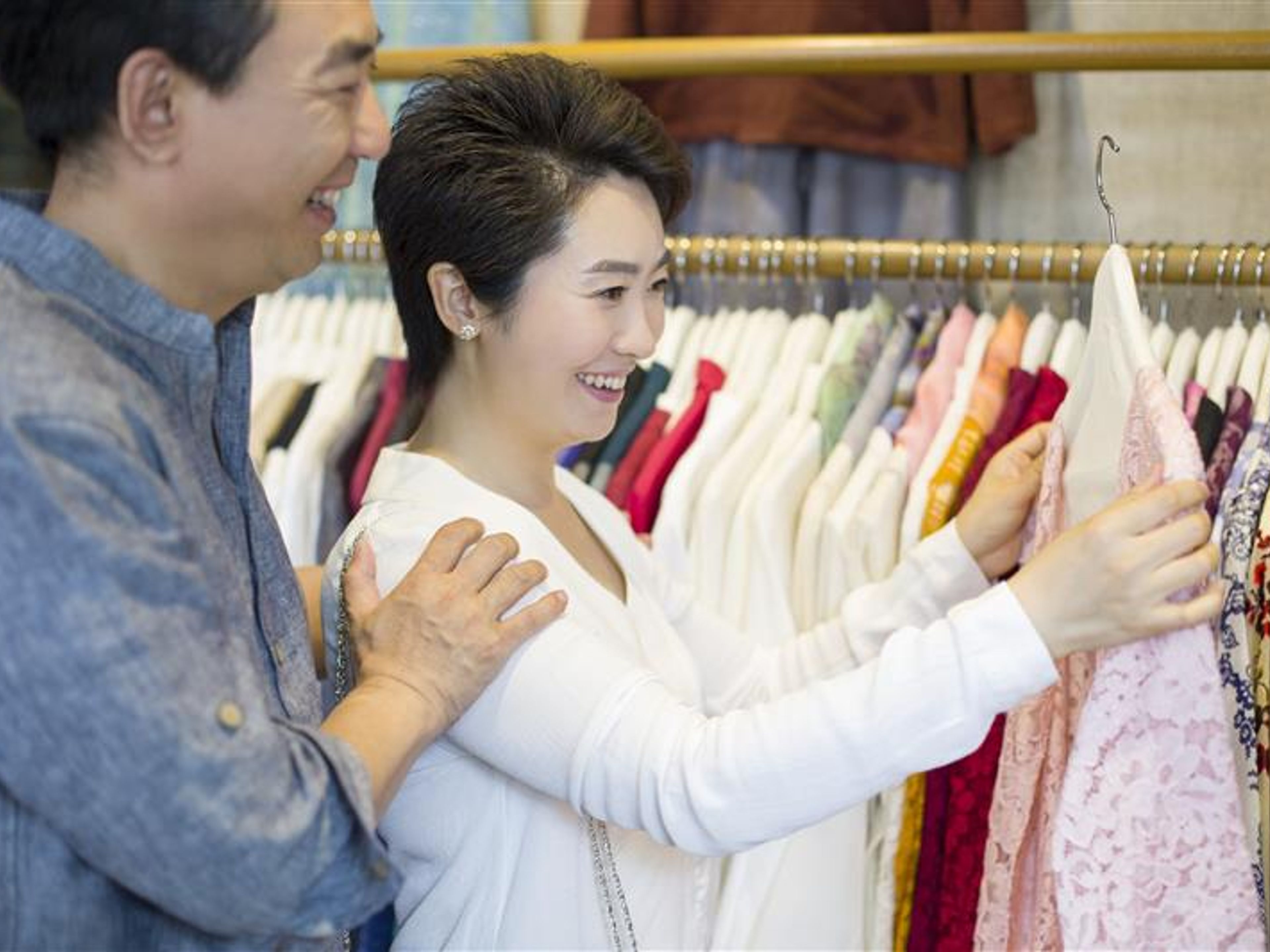 Couple shopping in clothing store.