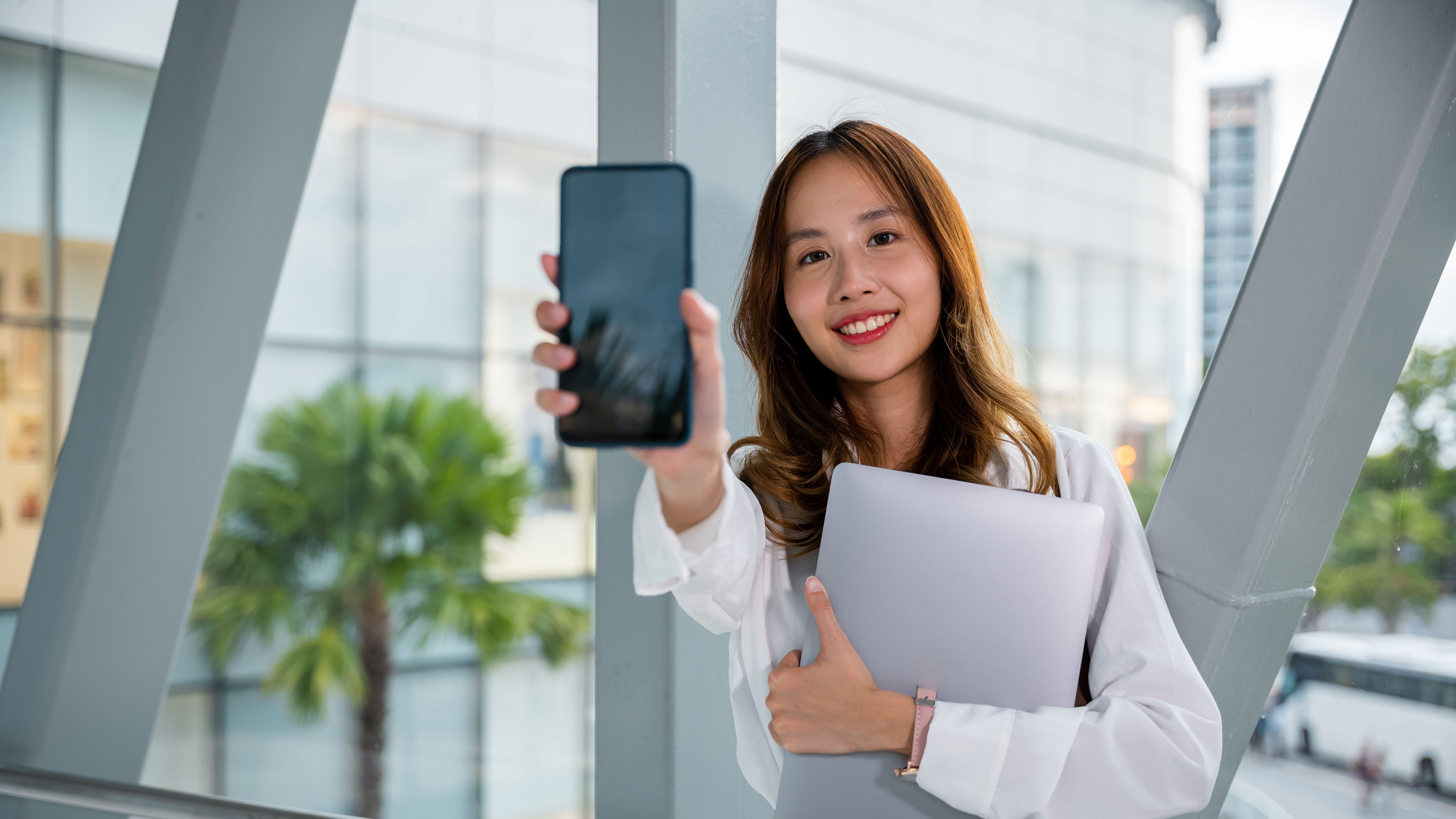 Professional woman uses her mobile phone in an airport