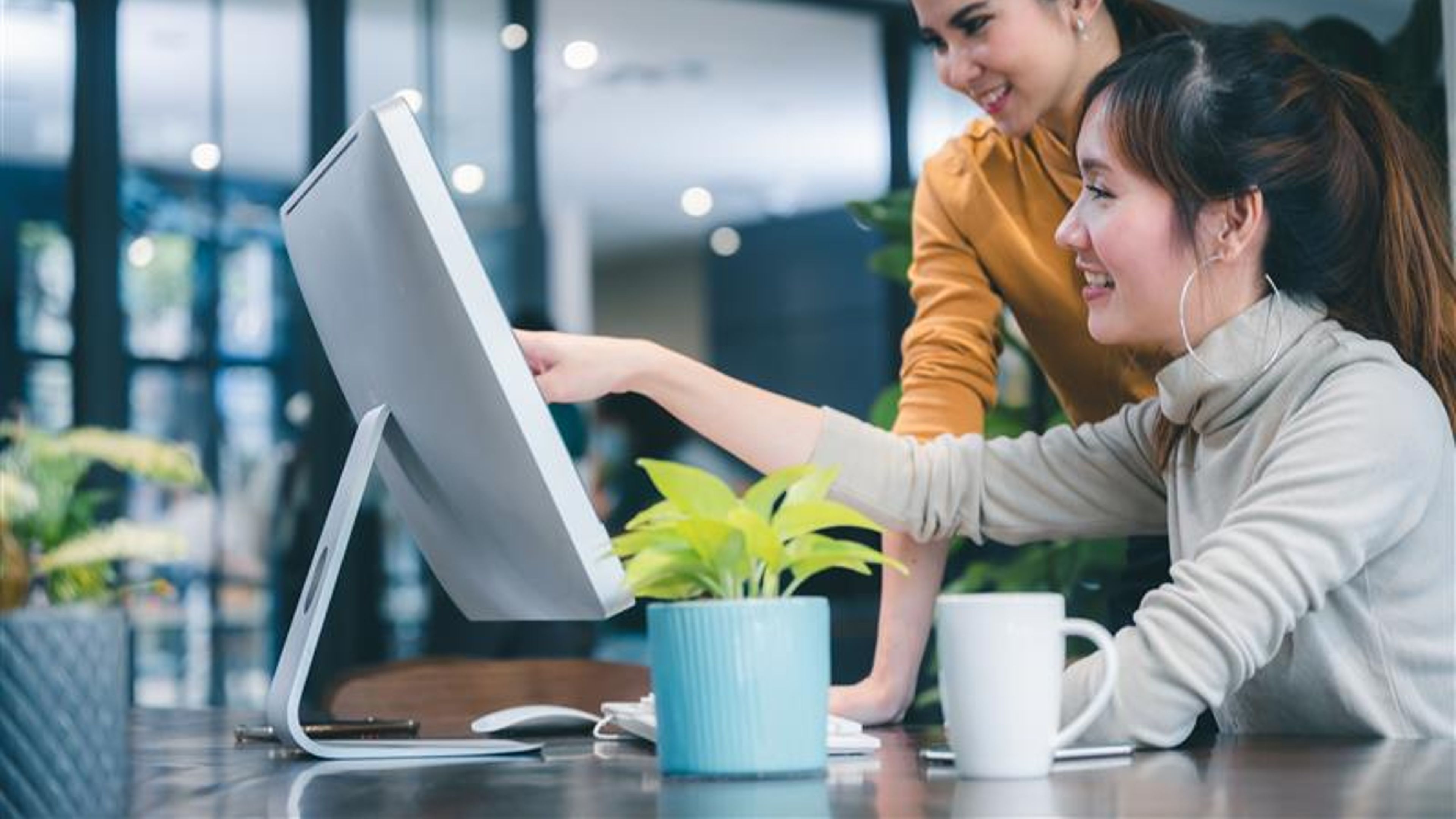Women looking at a monitor. 