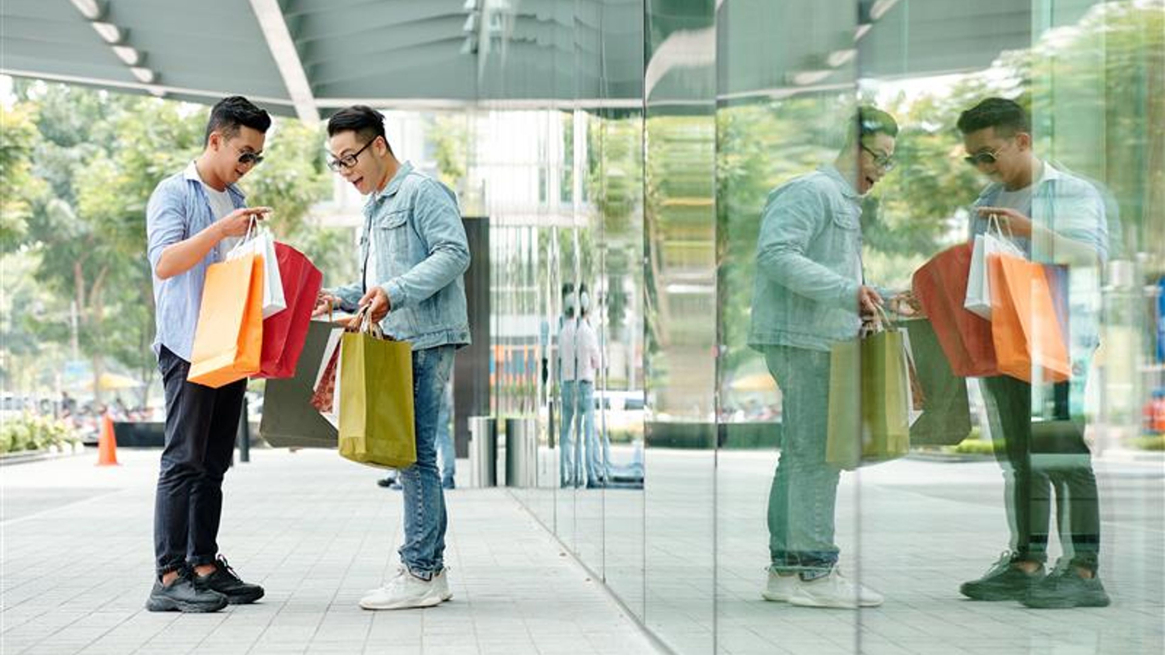 Men holding shopping bags.