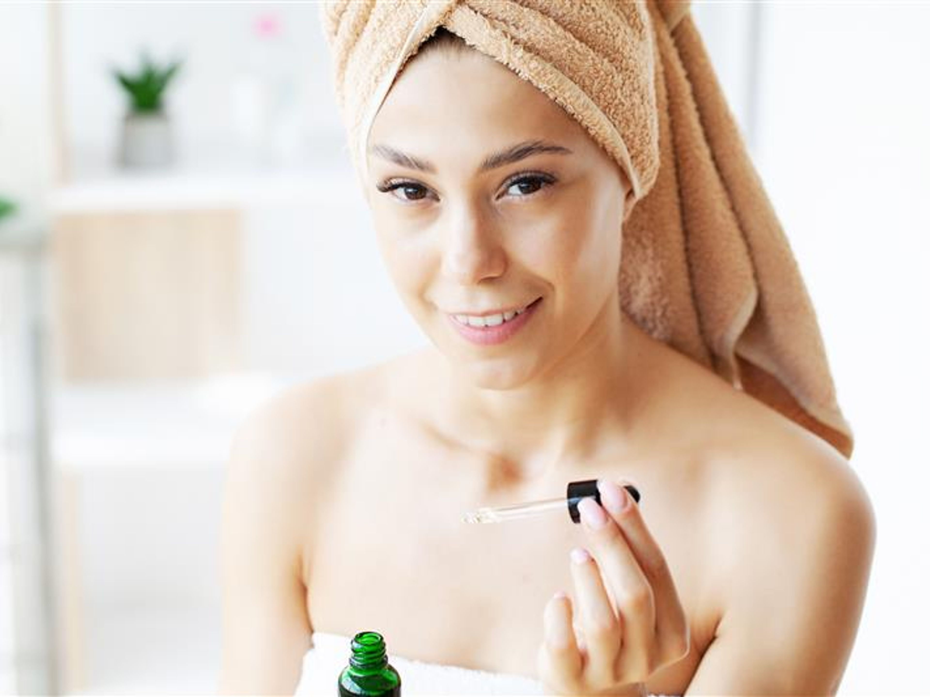 Woman with a drops of cream on her face