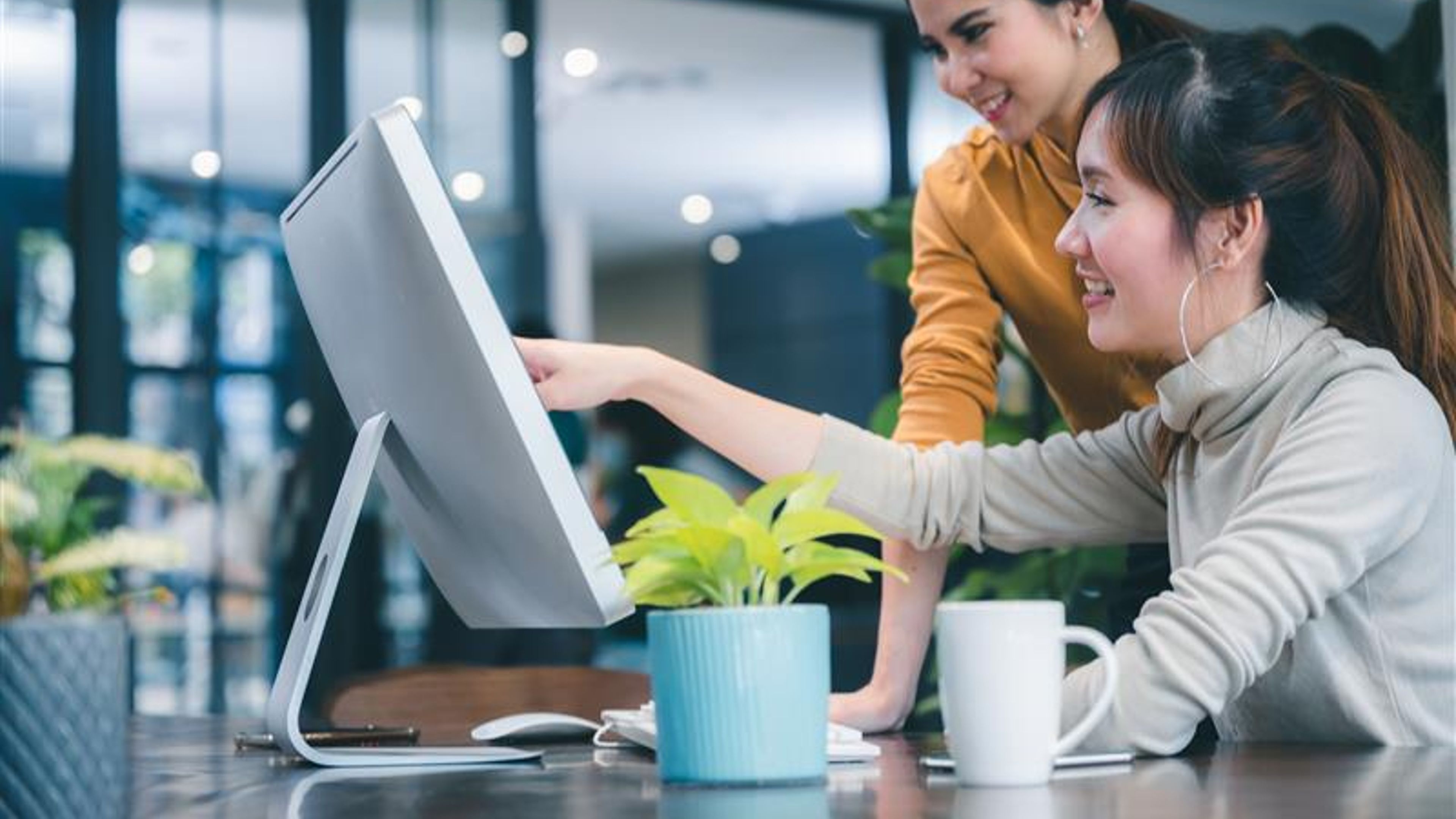 Women looking at a monitor. 